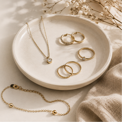 Jewelry collection on a plate with text about building a minimalist jewelry collection.